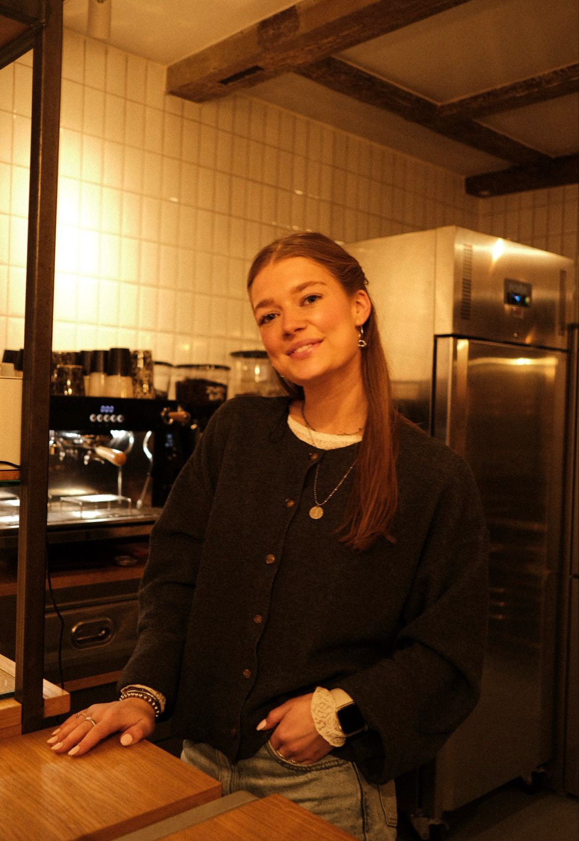 Girl smiling behind the bar